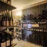 Wine cellar, © Lukas Kirchgasser A wine cellar with shelves full of wine bottles neatly stacked.