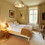 Apartment Steinfeld in der Villa Tranquillini, © Herbert Lehmann Gemütliches Schlafzimmer mit Doppelbett, Schreibtisch und großem Fenster.