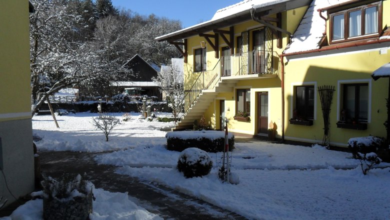 Pension Hendling in winter, © Josef Hendling Yellow building in the snow with blue sky.