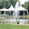 Wedding pavilion, © Besta Betriebs GmbH A wedding pavilion and tents next to a pond with a fountain in a garden.
