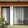 The guest house in the Triad, © Marketing Platzhirsch, Gobauer Modern terrace with two chairs and a table in front of a guest house.