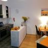 Kitchen in the breakfast room, © Pension zum Spitz Modern kitchen with dining table and orange placemats.
