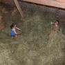 during haymaking, © Wachahof Two people working in a hayloft with pitchforks.