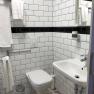 Bathroom, © Pension zum Spitz Modern bathroom with white tiles, washbasin and toilet.