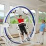 The world's only three-dimensional therapy device, © Gesundheitsresort Königsberg Person in a three-dimensional therapy device with another person next to them.