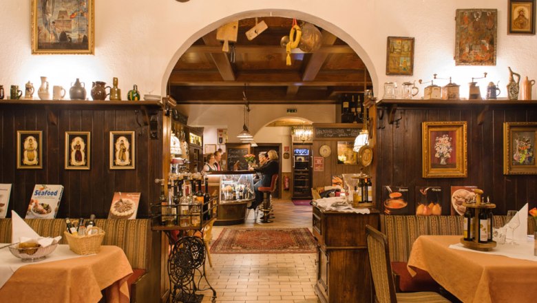 Cozy dining room with wooden furniture and decorations in the Hotel Post-Hönigwirt.