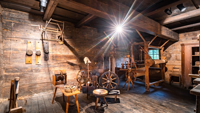 Interior view of an old workshop with wooden tools and spinning wheels in the Krumbach museum village.