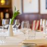 Elegant table at the Hotel Post with wine glasses, candle and flower vase.