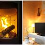 A burning fireplace and a cozy living room with TV, lamp and decoration.