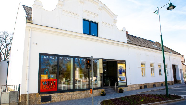 A white building with shop windows
