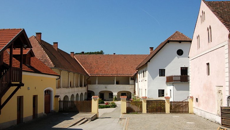 Innenhof des Dominikalhofs Bromberg mit historischen Geb&auml;uden und roten Ziegeld&auml;chern.