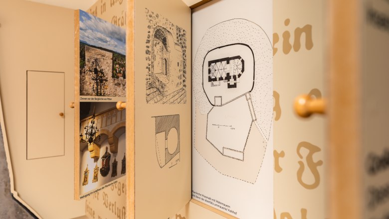 Close-up of an exhibition on fortified church documentation with drawings and photos.